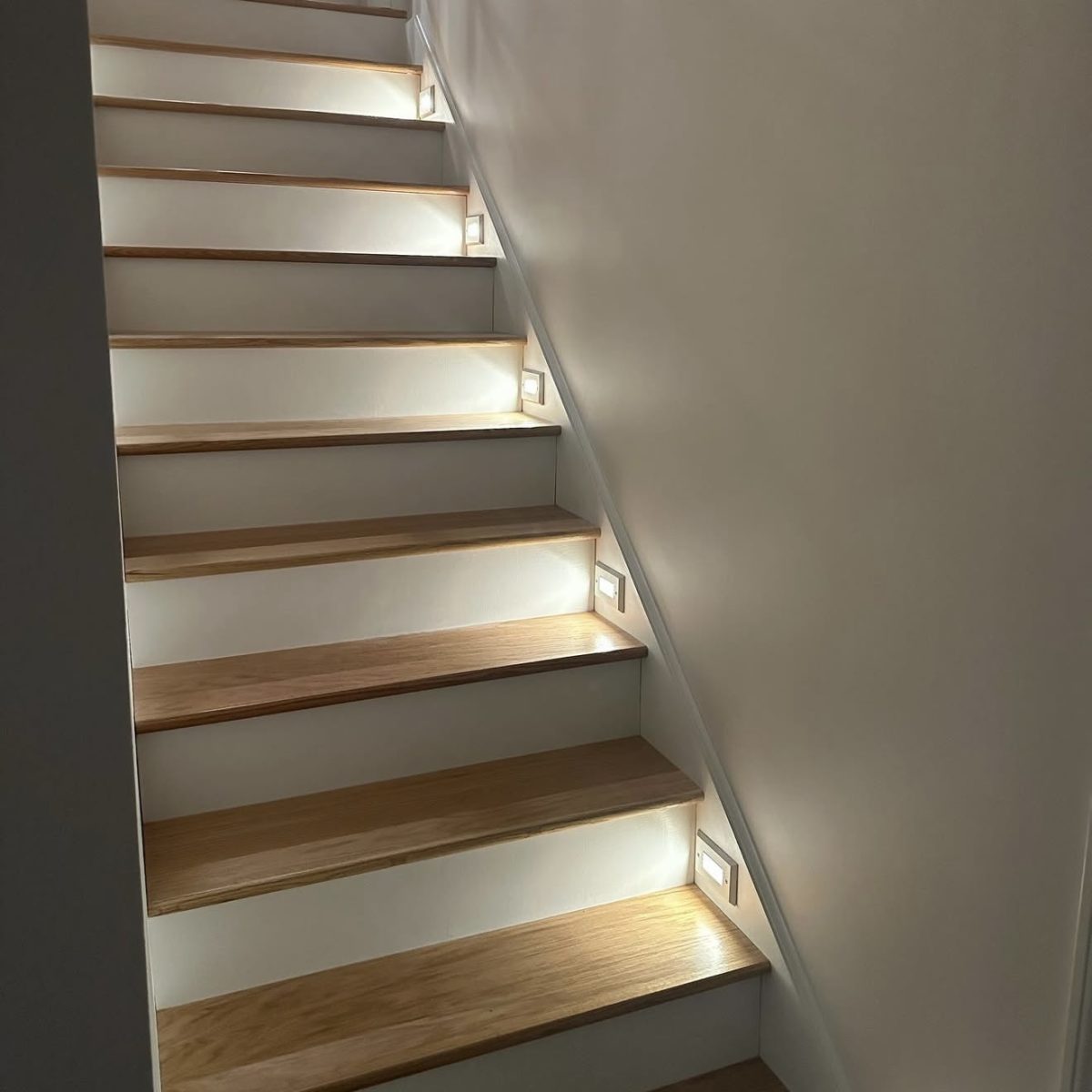 Stairway lighting installation in Connecticut home by licensed electrician. Modern LED lights for safety and design.