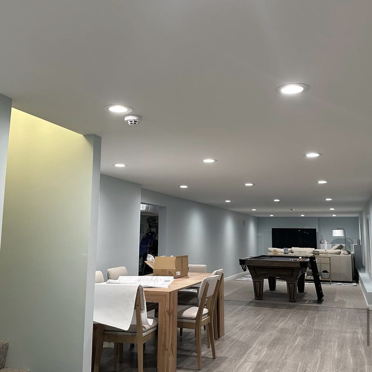 Basement ceiling lighting installation in Connecticut by licensed electrician. Modern, energy-efficient recessed fixtures.